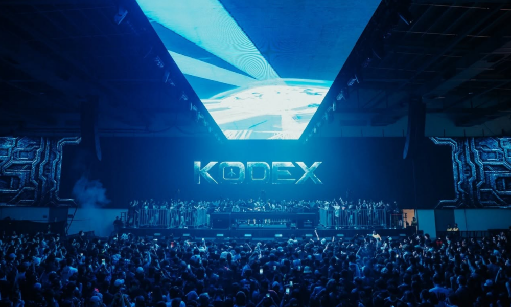 KODEX TERMINAL stage at XOX Arena in Kuala Lumpur, featuring the KODEX logo across the main screen, overhead LED panels, and a large crowd.