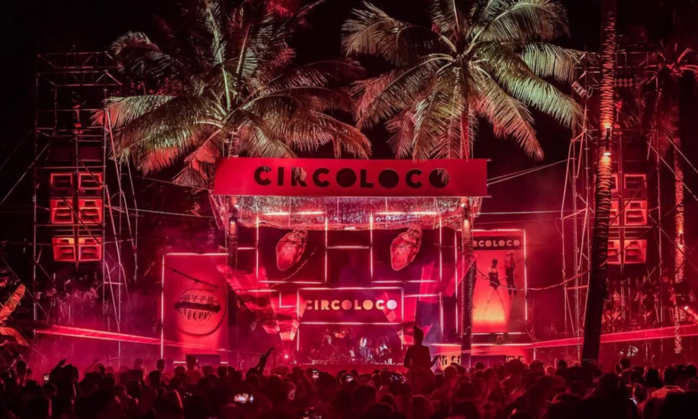 Circoloco Thailand at Baba Beach Club Natai in Phuket, with the red Circoloco stage surrounded by palm trees and a large crowd at night.