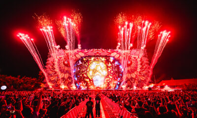 Red fireworks and pyrotechnics exploding above the Djakarta Warehouse Project (DWP) mainstage as the crowd raises their hands