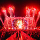 Red fireworks and pyrotechnics exploding above the Djakarta Warehouse Project (DWP) mainstage as the crowd raises their hands