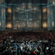 Armin van Buuren performing in front of a large crowd beneath the stage production at A State of Trance