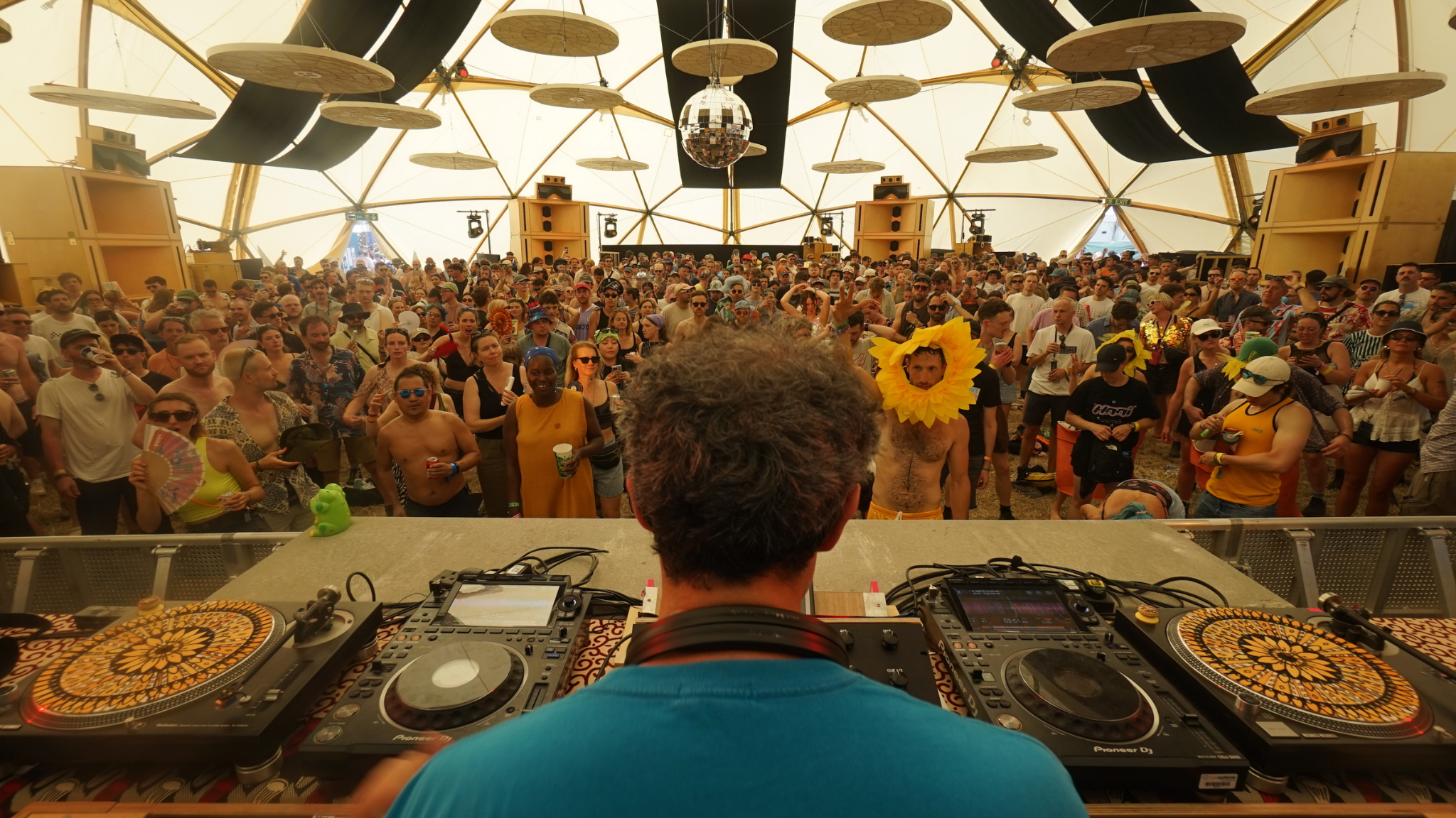 Floating Points performing inside the Sunflower Sound System with custom speaker stacks surrounding the audience
