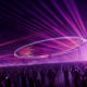 Head Trip stage design featuring a large circular overhead structure, purple lighting and a crowd in front of the stage