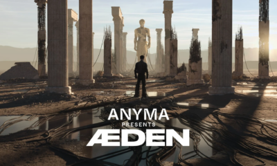 Anyma presents ÆDEN artwork showing a futuristic ruined landscape with towering columns, a central statue and the ÆDEN logo in the foreground