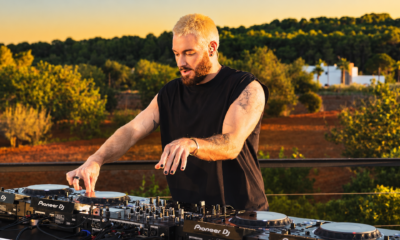 James Hype performing on several Pioneer DJ decks during an outdoor set