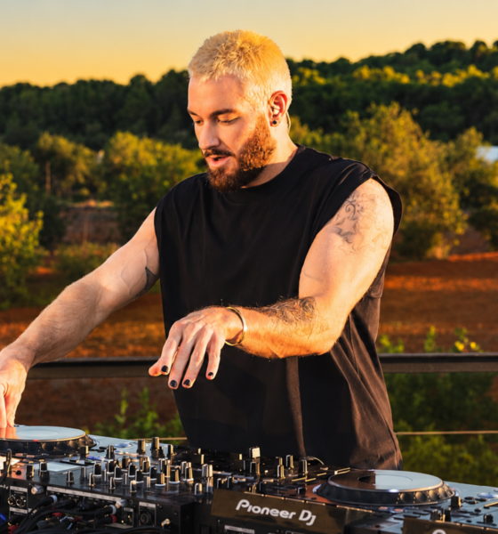 James Hype performing on several Pioneer DJ decks during an outdoor set