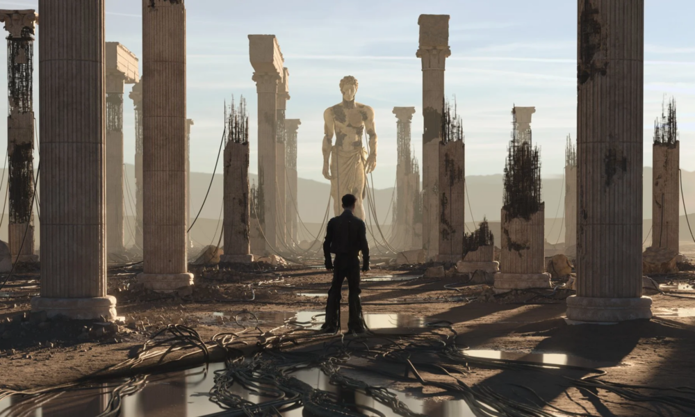 Anyma ÆDEN visual featuring a lone figure surrounded by ruined classical columns, exposed structures and a large statue in the distance.