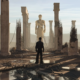 Anyma ÆDEN visual featuring a lone figure surrounded by ruined classical columns, exposed structures and a large statue in the distance.