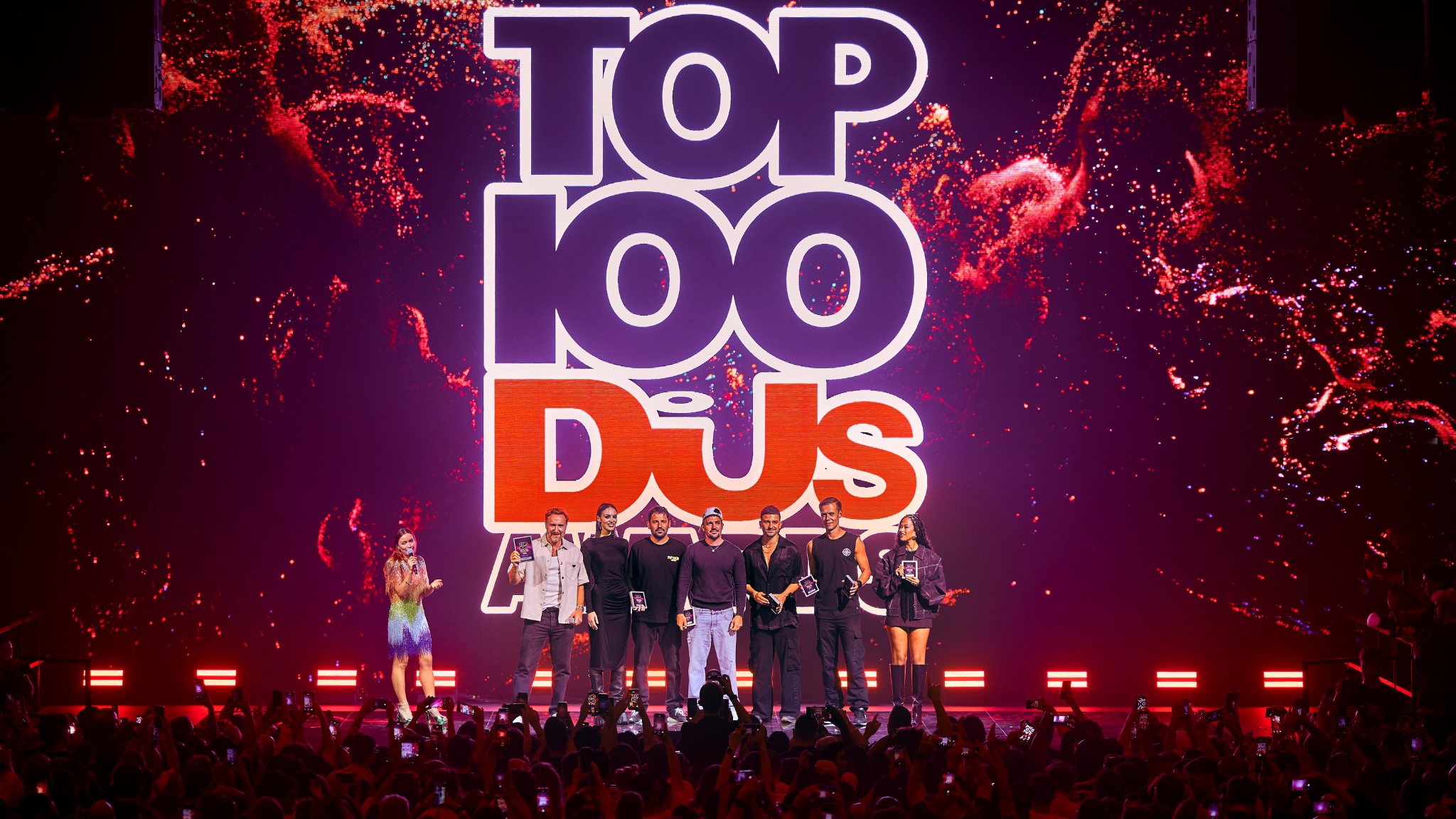 Top 100 DJs Awards ceremony on stage at [UNVRS] in Ibiza with several artists holding awards in front of the crowd