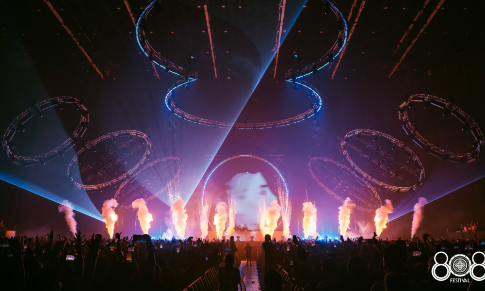 808 Festival stage at BITEC Bangna with circular lighting rigs, lasers, smoke effects and a large crowd