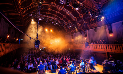 Audience watching a live performance inside an atmospheric historic music venue.