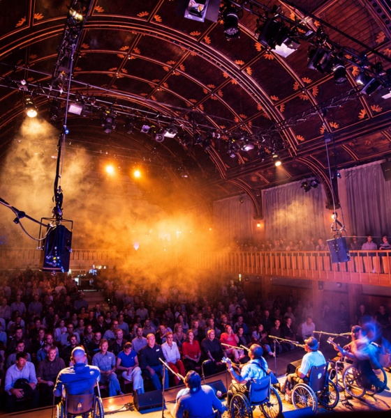 Audience watching a live performance inside an atmospheric historic music venue.