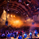 Audience watching a live performance inside an atmospheric historic music venue.