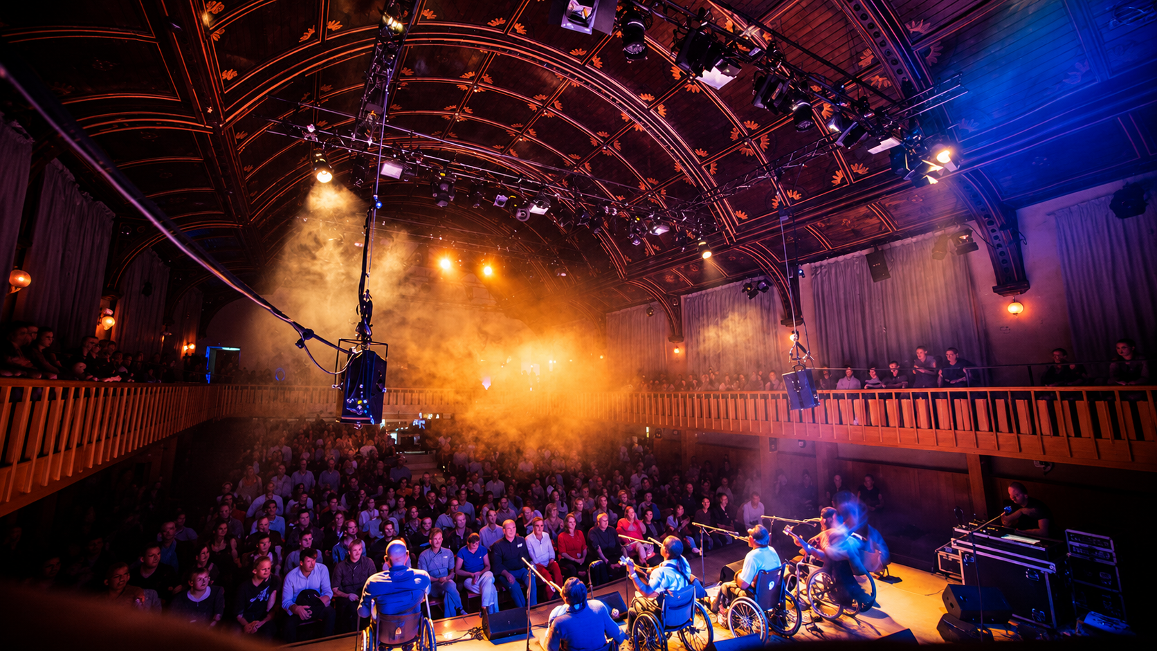 Audience watching a live performance inside an atmospheric historic music venue.