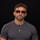 Promotional portrait of Two Phased producer Stephen wearing sunglasses against a dark background.