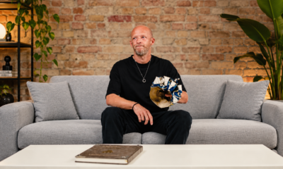 High-Tech Minimal DJ Boris Brejcha sits on a sofa holding his distinctive Joker mask during an announcement about his retirement and final tour.
