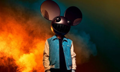 deadmau5 wearing his mau5head helmet against a smoky orange and blue background