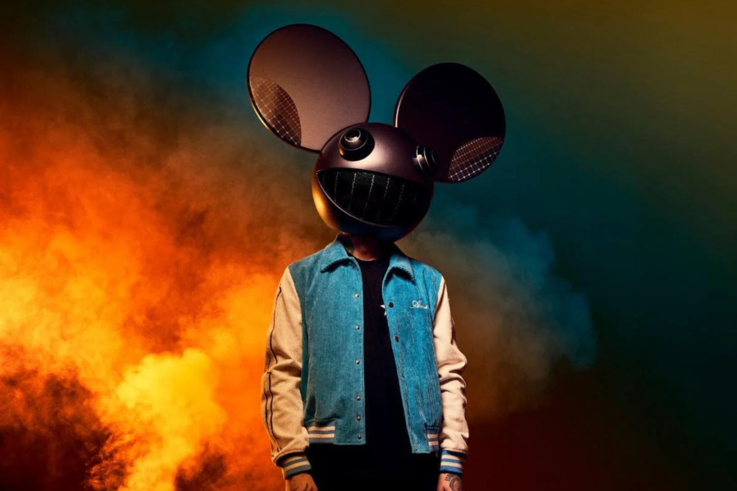 deadmau5 wearing his mau5head helmet against a smoky orange and blue background