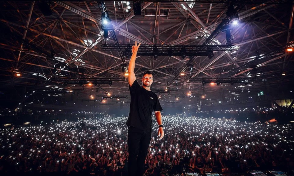 Martin Garrix performing on stage in front of a large crowd