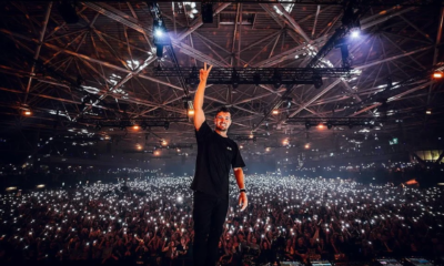Martin Garrix performing on stage in front of a large crowd