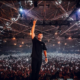 Martin Garrix performing on stage in front of a large crowd