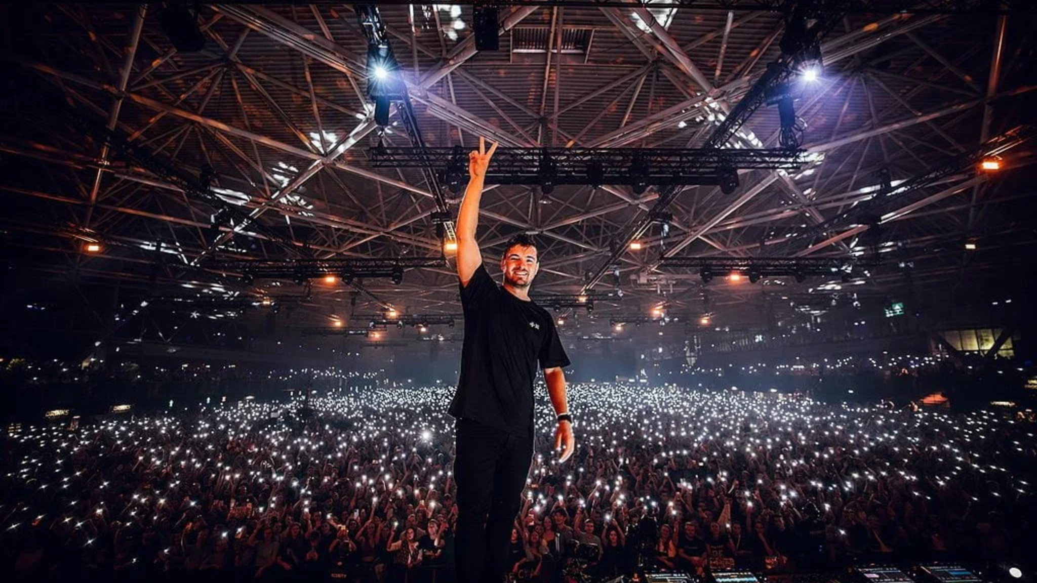 Martin Garrix performing on stage in front of a large crowd