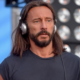 Bob Sinclair wearing silver headphones during a live performance