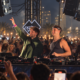 John Summit and Max Styler performing together behind the decks in front of a large outdoor crowd
