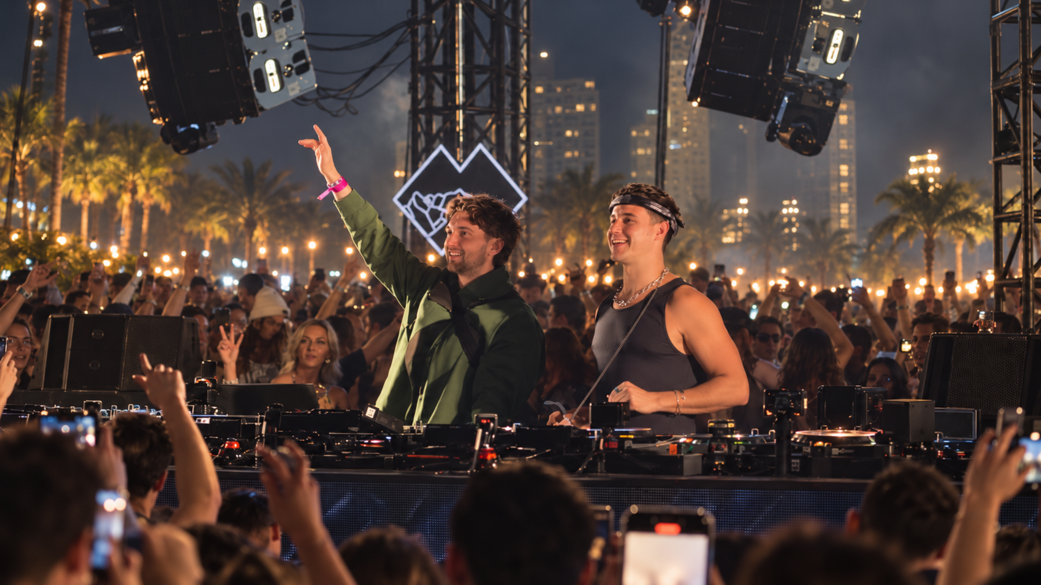 John Summit and Max Styler performing together behind the decks in front of a large outdoor crowd