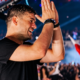 Martin Garrix clapping onstage during a live festival performance