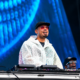 Afrojack smiling behind the DJ decks during a live festival performance