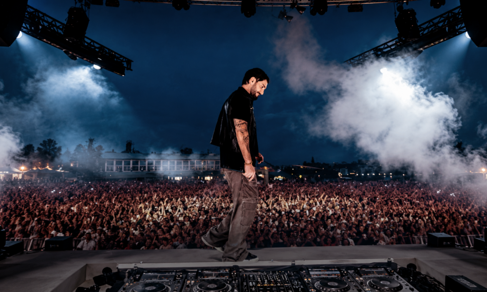 Alesso performing on stage in front of a large crowd, featured in New EDM Friday Oct 16