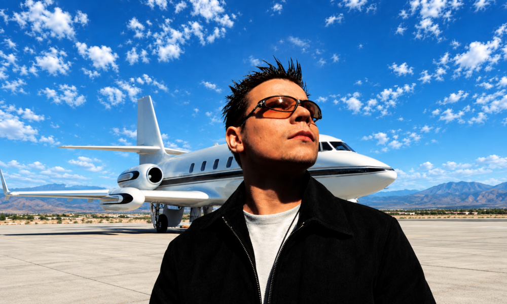 ATB standing in front of a private jet for the 28th anniversary of his trance classic 9 PM