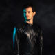 Aurory wearing a black jacket against a dark background for his new single Telekinesis on Deer Deer Music