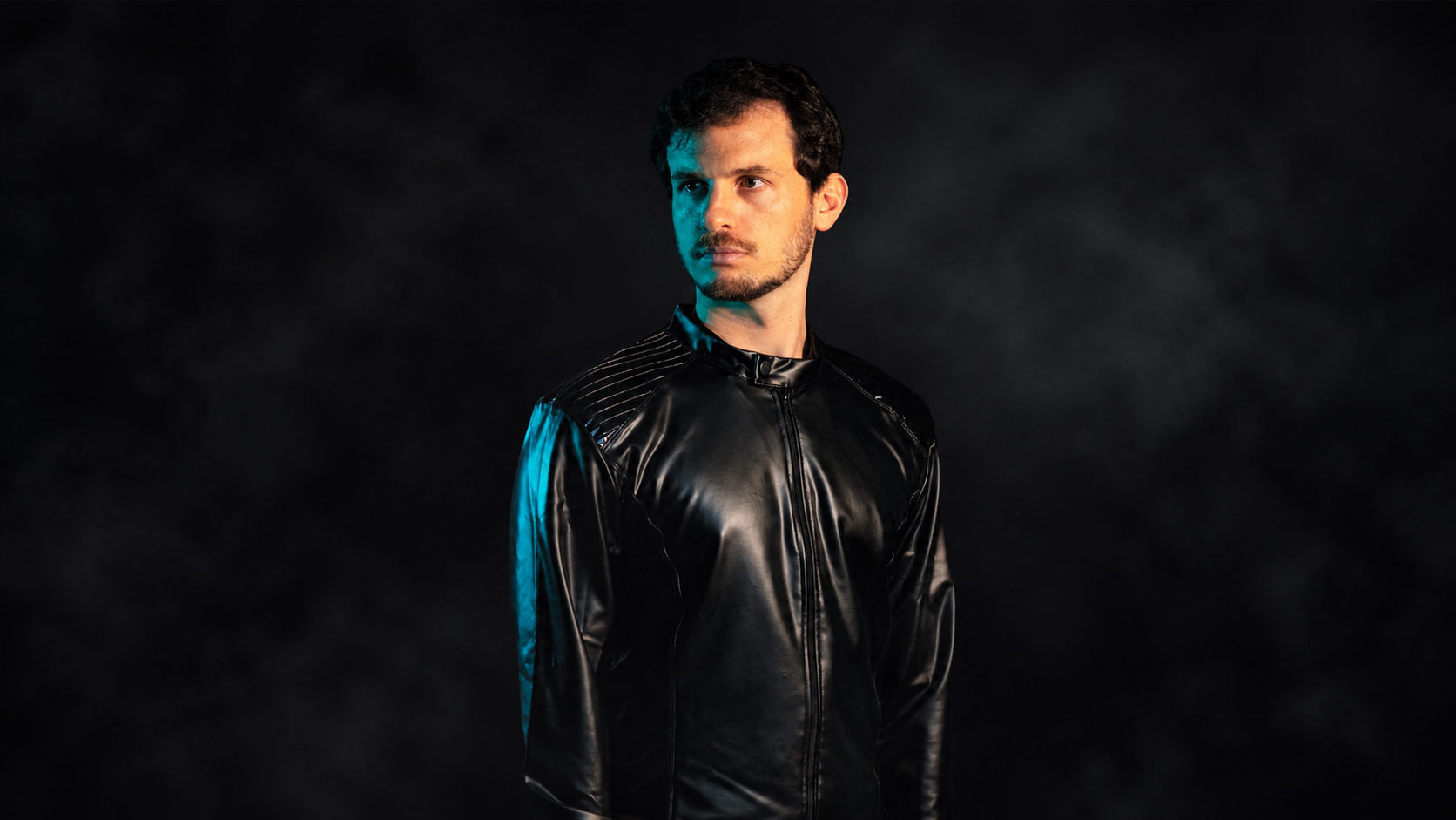 Aurory wearing a black jacket against a dark background for his new single Telekinesis on Deer Deer Music
