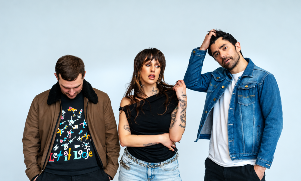 Dev and The Cataracs posing together in a promotional photo
