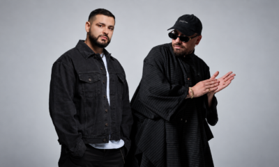 GROSSOMODDO and MOSKA posing together in black outfits against a light grey studio background