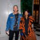 M.I.A. and Diplo posing together indoors at an event.