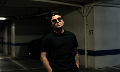 Nico Falla wearing dark clothing and blue sunglasses in a promotional portrait for his electronic music releases. Copy image title Copy alt text