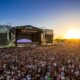 Huge crowd facing the Lollapalooza main stage at sunset