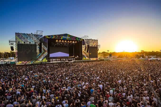 Huge crowd facing the Lollapalooza main stage at sunset