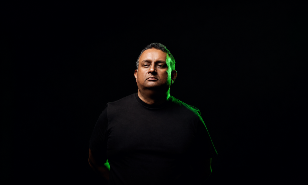 Midnight Evolution wearing a black shirt against a dark background for his new single Meridian on Interplay Flow