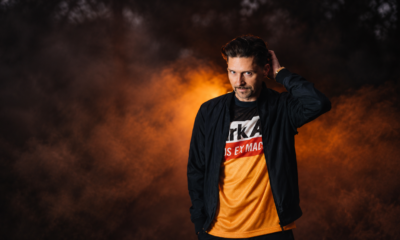 Nico Morano photographed against an orange and black background for his album Forever Ever Dancer