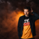 Nico Morano photographed against an orange and black background for his album Forever Ever Dancer