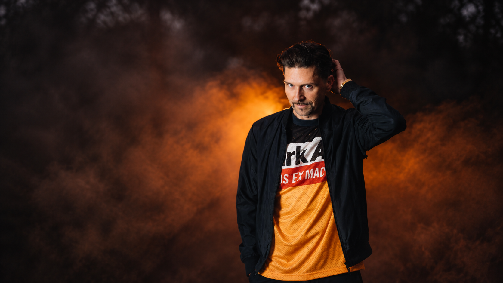 Nico Morano photographed against an orange and black background for his album Forever Ever Dancer