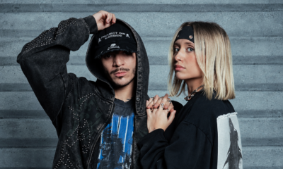 Nico Moreno and Novah posing together in black outfits against a concrete wall