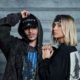 Nico Moreno and Novah posing together in black outfits against a concrete wall