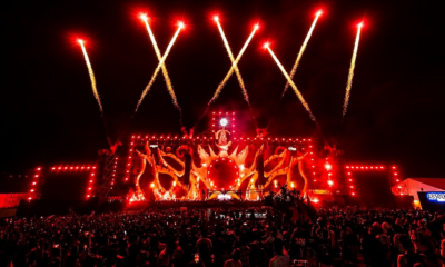 Sunburn Festival stage glowing red as fireworks launch above a large nighttime crowd.